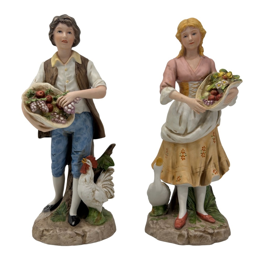 Couple of porcelain peasant figurines with animals and fruit baskets